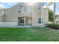 Two-story home featuring a well-maintained lawn, neutral paint scheme, and inviting front entrance at 6955 Della Dr # 41, Orlando, FL 32819