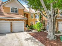 Charming two-story home with a two-car garage and well-maintained landscaping at 7323 Cypress Grove Rd # 87, Orlando, FL 32819