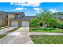 Charming townhome with two-car garage and well-manicured front lawn, perfect for suburban living at 8248 Limetree Ct, Orlando, FL 32836