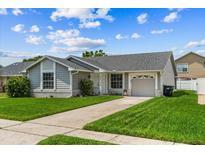 Charming single-story home with well-maintained lawn, mature landscaping, and covered entryway at 9447 Brackin St, Orlando, FL 32825