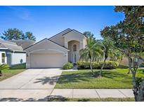 Charming two-story home featuring a well-maintained lawn and a two-car garage at 12756 Maribou Cir, Orlando, FL 32828