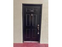 Close-up of a black door with a knocker and security lock at 2007 Dixie Belle Dr # 2007 M, Orlando, FL 32812