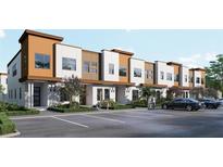 Modern townhome featuring stylish architecture, a well-kept landscape, and convenient parking at 213 Breezeway Dr, Davenport, FL 33897
