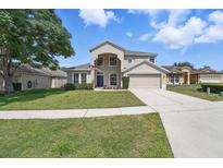 Charming two-story home featuring a well-manicured lawn and inviting curb appeal at 231 Chestnut Creek Dr, Apopka, FL 32703