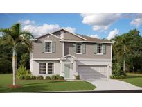 Two-story home with gray siding, light green shutters, a manicured lawn, and a two-car garage at 245 Streamliner Way, Groveland, FL 34736