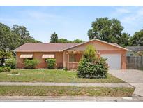 Charming single-story home with a well-maintained front yard and attached garage at 2933 N Chickasaw Trl, Orlando, FL 32817