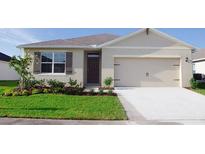 Charming single-story home featuring a two-car garage, well-manicured lawn, and neatly landscaped front yard at 5145 Masser Rd, St Cloud, FL 34772