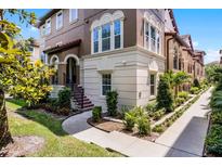 Beautiful two-story home featuring landscaped gardens, an arched entryway and a private staircase at 524 Lobelia Dr, Lake Mary, FL 32746