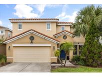 Charming two-story home features a tile roof, two car garage and mature landscaping at 5353 Oakbourne Ave, Davenport, FL 33837