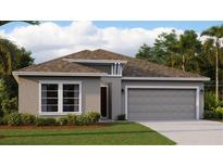 Charming single-story home features a two-car garage, manicured lawn, and thoughtfully designed front elevation at 7546 Headwaters Ct, Groveland, FL 34736