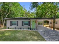 Charming single-story home featuring a bright green front door and a covered carport at 900 Citrus St, Orlando, FL 32805