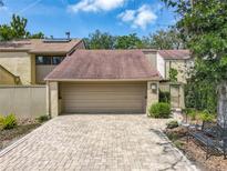 Charming townhome featuring a two-car garage and paved driveway and walkway at 103 Red Cedar Dr, Longwood, FL 32779