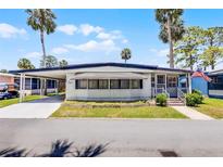 Charming single-story home with a well-maintained lawn and covered parking at 200 Palm Meadows Dr, Eustis, FL 32726