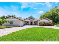 Stunning exterior with manicured lawn, brick driveway, and beautiful landscaping at 2106 Tuscarora Trl, Maitland, FL 32751