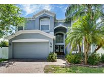 Charming two-story home with a well-manicured lawn and a two-car garage at 2349 Plantation Oak Dr, Orlando, FL 32824