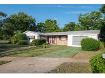Charming single-story home with a well-maintained lawn, front shrubs and a brick front entry at 2361 Kimberly Dr, Deltona, FL 32738