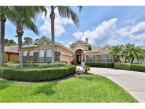 Beautiful single-story home showcasing well-manicured landscaping and a welcoming circular driveway at 5154 Majestic Woods Pl, Sanford, FL 32771