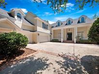 Inviting two-story home featuring a spacious driveway and traditional architectural details at 6161 Blakeford Dr, Windermere, FL 34786