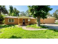 Charming single-story home with a well-maintained lawn and mature landscaping at 714 Herbert St, Port Orange, FL 32129
