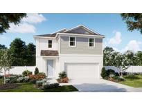 Charming two-story home with a modern design, two-car garage, and beautifully landscaped front yard at 734 Ginger Dr, Haines City, FL 33844