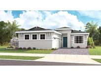 Charming single-story home featuring a brick paved driveway, manicured lawn, and tropical landscaping at 944 Club Cresswind Dr, Lady Lake, FL 32159