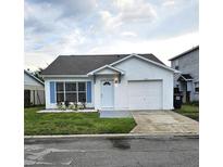 Charming single-story home featuring white stucco exterior, blue shutters, and a well-maintained lawn at 1025 Clovercrest Rd, Orlando, FL 32811