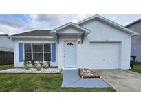 Charming home with blue shutters, a well-maintained lawn, and a one-car garage at 1025 Clovercrest Rd, Orlando, FL 32811