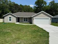 Charming single-story home with a well-manicured lawn and attached two-car garage at 10641 Sw 110Th Ct, Dunnellon, FL 34432
