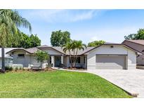 Charming single-story home with a well-manicured lawn, lovely landscaping, and a two-car garage at 1172 Trotwood Blvd, Winter Springs, FL 32708