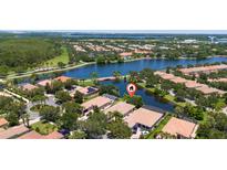Stunning aerial view of the community surrounding a lake and luxury homes at 12185 Obelia Ln, Orlando, FL 32827
