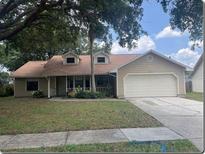 Charming single-story home with a two-car garage and well-maintained front yard at 1606 Red Clover Ct, Orlando, FL 32825
