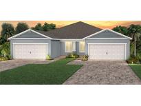 Beautiful, light blue single-story home with a well-maintained lawn, a two-car garage and a brick driveway at 2322 Daisy Tree Rd, St Cloud, FL 34771