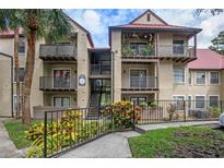 Inviting condo exterior with balconies, lush landscaping, and convenient stair access at 238 Afton Sq # 106, Altamonte Springs, FL 32714