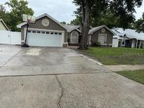 Charming single-story home featuring a two-car garage and driveway, a basketball hoop, and easy lawn maintenance at 2514 Dovetail Dr, Ocoee, FL 34761