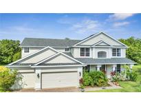 Charming two-story home featuring a three-car garage and well-maintained landscaping at 4394 Devon Ct, Kissimmee, FL 34746