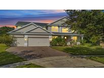 Beautiful two-story home featuring a three-car garage and well-maintained landscaping at 4394 Devon Ct, Kissimmee, FL 34746
