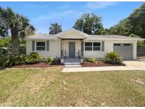 Charming single-story home with a well-maintained lawn and colorful landscaping at 520 Sumner Ave, Orange City, FL 32763