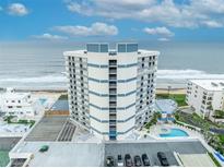 Luxury beachfront condo building with a swimming pool and panoramic ocean views at 5207 S Atlantic Ave # 225, New Smyrna Beach, FL 32169