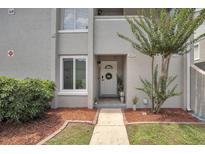 Charming condo with a welcoming front door and well-maintained landscaping at 5635 Blue Shadows Ct # 3, Orlando, FL 32811