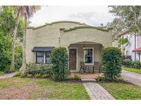 Charming stucco home with a brick walkway, covered porch, and lush landscaping at 1012 W New Hampshire St, Orlando, FL 32804