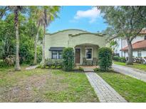 Charming front exterior with a neatly paved walkway and mature landscaping at 1012 W New Hampshire St, Orlando, FL 32804