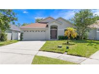Charming single-story home with a well-manicured lawn and attached two-car garage at 11218 Rouse Run Cir, Orlando, FL 32817