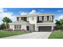 Stunning two-story home with a beautifully landscaped yard and a brick paved driveway at 149 Purcell Dr, Alafaya, FL 32825