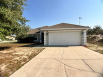 Charming single-story home with a two-car garage and well-maintained landscaping at 1715 Redfin Way, Kissimmee, FL 34759