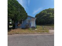Charming single-story home with a blue exterior, white door, and mature tree in the front yard at 2031 Warrens Ave, Maitland, FL 32751