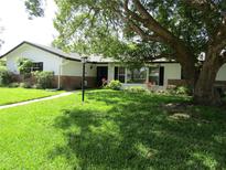 Charming single-story home with well-maintained lawn and mature trees at 2632 Derbyshire Rd, Maitland, FL 32751