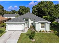 Charming single-story home featuring a well-manicured lawn and attached two-car garage at 2710 Autumn Ln, Eustis, FL 32726