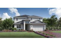 Charming two-story home with a manicured lawn, colorful flower beds, and an attached two-car garage at 2715 Arbor Dune Ave, Apopka, FL 32712