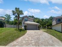 Charming home featuring a lush landscaped yard and a paved driveway leading to the garage at 306 Foxboro Ct, Lake Mary, FL 32746
