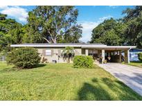Charming single-story home with a well-maintained lawn and a covered carport at 3118 Walnut St, Winter Haven, FL 33881